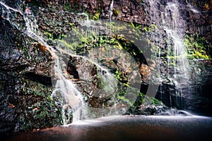 Cascading waterfall into shallow rock pool