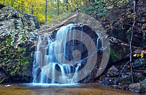 Cascading woodland waterfall and fall foliage