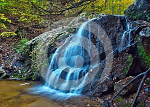 Cascading woodland waterfall and fall foliage