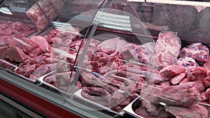 case in butcher shop with raw meat of turkey, butchered poultry meat