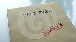 Case files declassified, seal stamped on folder with important documents, close photo