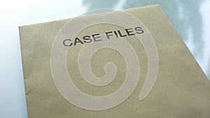 Case files, folder with important documents lying on table, information close up