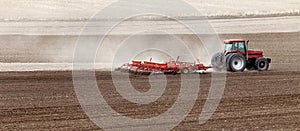A Case International tractor pulling a plowing implement, plows an Idaho farm field