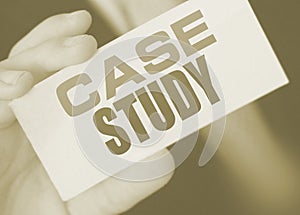 Case study, message on white card in hand of businessman