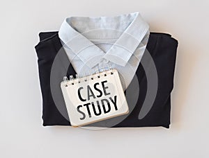 Case Study text written on a notebook lying on a shirt, the concept of the school of the working week