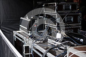 Cases and racks from a sound amplification system for an event on an open-air stage