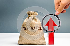 A cash bag with the word Surcharge and a red up arrow. Increase in fine and penalties for violating. The system of cumulative