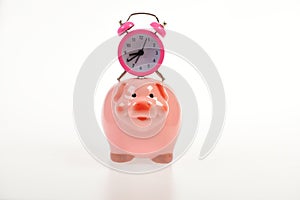 Cash box with financial income. Piggy bank with alarm clock.