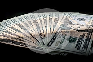 Cash fanned out on a black background