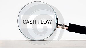 Cash flow text written through a magnifying glass