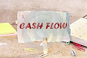 Cash flow text written on a piece of paper in a clothespin