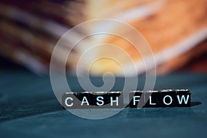 Cash flow on wooden blocks. Business and finance concept.