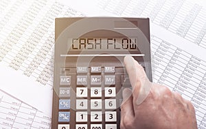 CASH FLOW word on calculator on financial documents with male hand