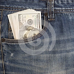 Cash in the front pocket of blue jeans closeup