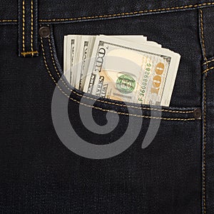 Cash in the front pocket of blue jeans closeup.