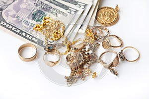 Cash for gold, used gold, old jewellery and coins with US dollar banknotes. Selling old or broken gold jewelry to get money