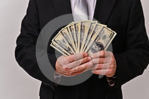 cash in the hands of a businessman. banknotes and money counting in US dollars, income and business concept.