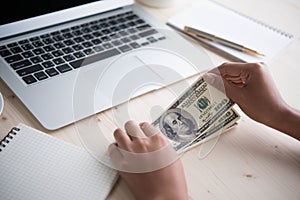 Cash in hands. Profits,savings. Stack of dollars