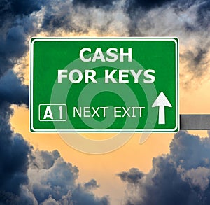 CASH FOR KEYS road sign against clear blue sky