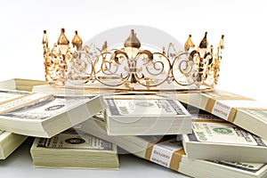 Cash is king, economic treasure and financial successful retirement conceptual idea with gold metal crown on pile of 100 dollar