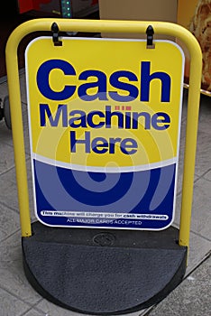 Cash machine here sign