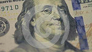 Cash money background. Benjamin Franklin portrait on 100 US dollar bill close up, the image is rotated