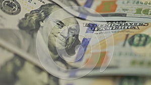 Cash money background. Benjamin Franklin portrait on 100 US dollar bill close up, the image is rotated