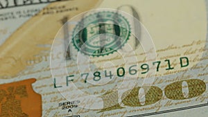 Cash money background. Benjamin Franklin portrait on 100 US dollar bill close up, the image is rotated