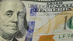 Cash money background. Benjamin Franklin portrait on 100 US dollar bill close up, the image is rotated