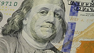 Cash money background. Benjamin Franklin portrait on 100 US dollar bill close up, the image is rotated