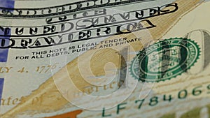 Cash money background. Benjamin Franklin portrait on 100 US dollar bill close up, the image is rotated