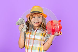 Cash money dollars bills and piggy bank concept. Boy saving money in a piggybank. Child boy with american dollars money.