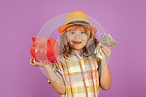 Cash money dollars bills and piggy bank concept. Boy saving money in a piggybank. Child boy with american dollars money.