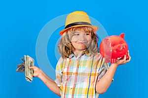 Cash money dollars bills and piggy bank concept. Kid saving money for purchase, hold pink piggy bank. Child learning to