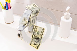 Cash Money Going Down Sink Drain Isolated on White Background