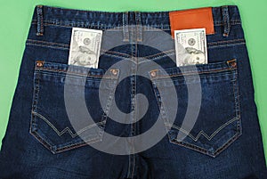 Cash, money is in the pocket of blue jeans.