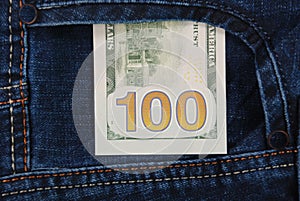 Cash, money is in the pocket of blue jeans.