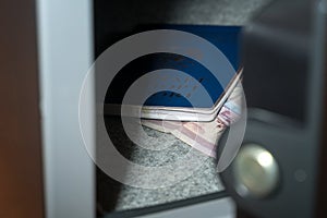 Cash Money Safe Deposit. Small Residential Vault with Cash Money and passport. Closeup Photo