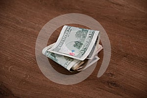 Cash money stack of US dollar bills folded in half