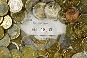 Euro coins and cash receipt with an amount of 18,50 Euro