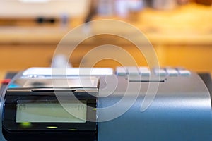 cash register installed on counter for accepting order from customer.sales man entering amount on electronic cash register in