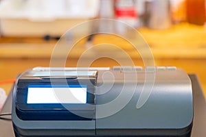 cash register installed on counter for accepting order from customer.sales man entering amount on electronic cash register in