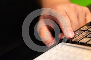 cash register installed on counter for accepting order from customer.sales man entering amount on electronic cash register in