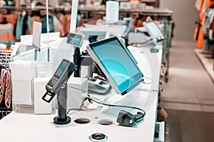 Cash register for paying for purchases in clothing boutique with a barcode scanner and a digital terminal. Seller workplace in