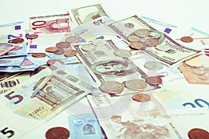 Cash on table isolated: dollars, euro, rubl broken money. All in