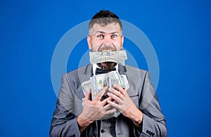Cash transaction business. Easy cash loan. Man formal suit hold many dollar banknotes blue background. Businessman got