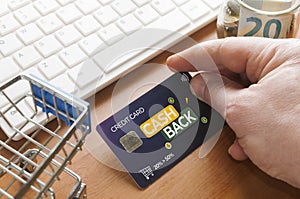 Cashback concept: man do online shopping with a cashback credit card