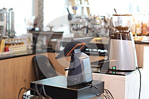 Casher machine with blurred coffee shop counter background