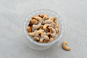 Cashew Nut, in Indonesia known as Kacang Mete. Served in a small bowl on grey background. photo