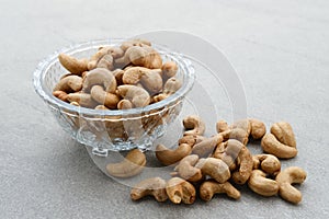 Cashew Nut, in Indonesia known as Kacang Mete. Served in a small bowl on grey background. photo